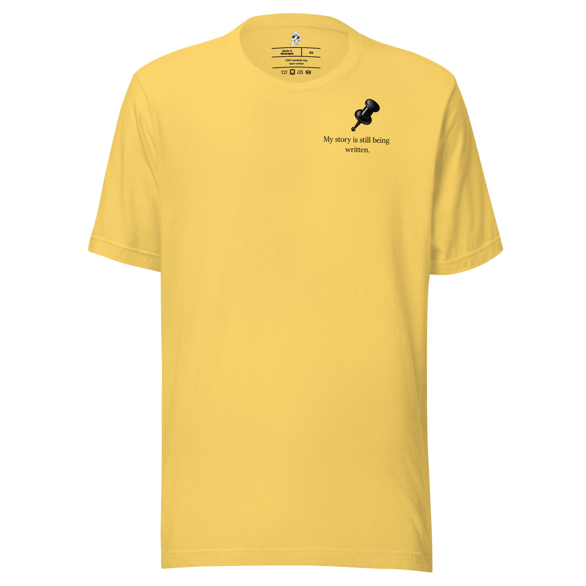 Front view of yellow t-shirt featuring My Story Is Still Being Written slogan.