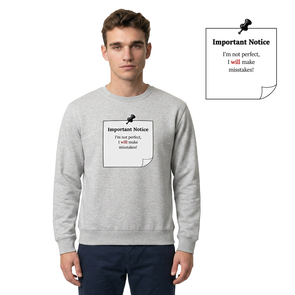 A man in grey track bottoms wearing a grey classic jumper, featuring a printed black-outlined square note with a black pushpin. The note displays the slogan: 'Important Notice: I’m not perfect, I will make mistakes,' with 'will' in bold red for emphasis.