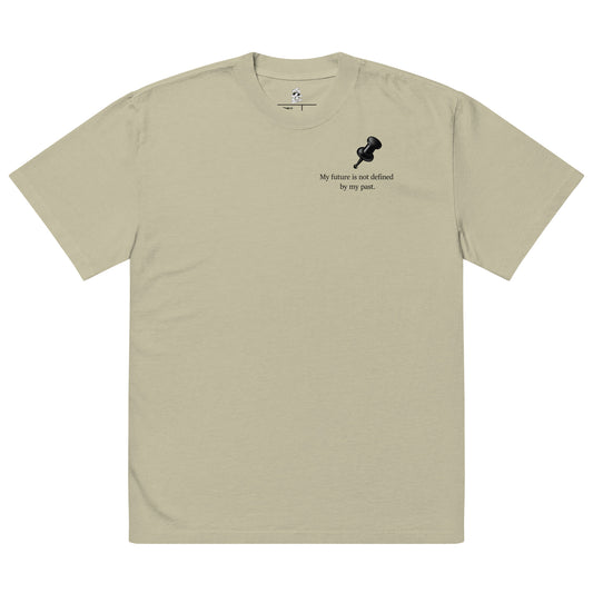 Front view of oversized faded eucalyptus t-shirt with My Future Is Not Defined by My Past slogan.