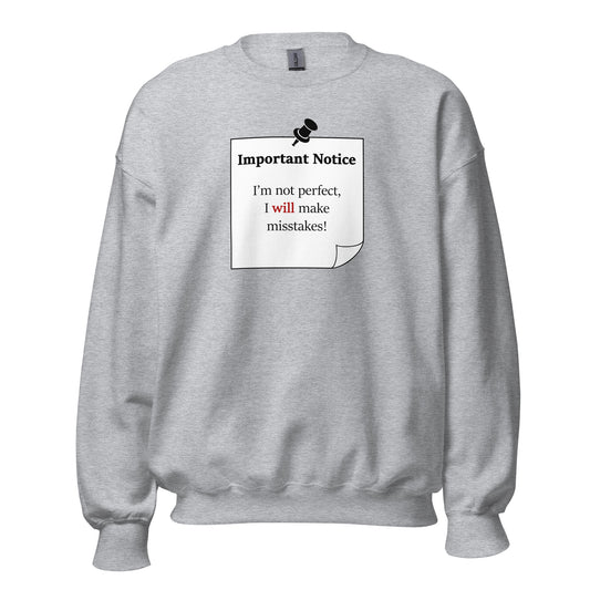 A unisex sports-grey classic crew neck jumper featuring a printed black-outlined square note with a white background and a black pushpin at the top centre. The note displays the slogan: "Important notice: I’m not perfect, I will make mistakes" in black, with the word will highlighted in bold red for emphasis.