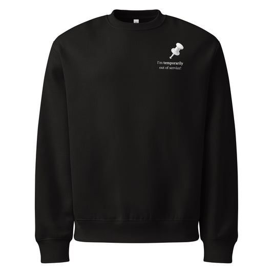 Black oversized heavyweight sweatshirt with “I’m temporarily out of service” white slogan graphic.