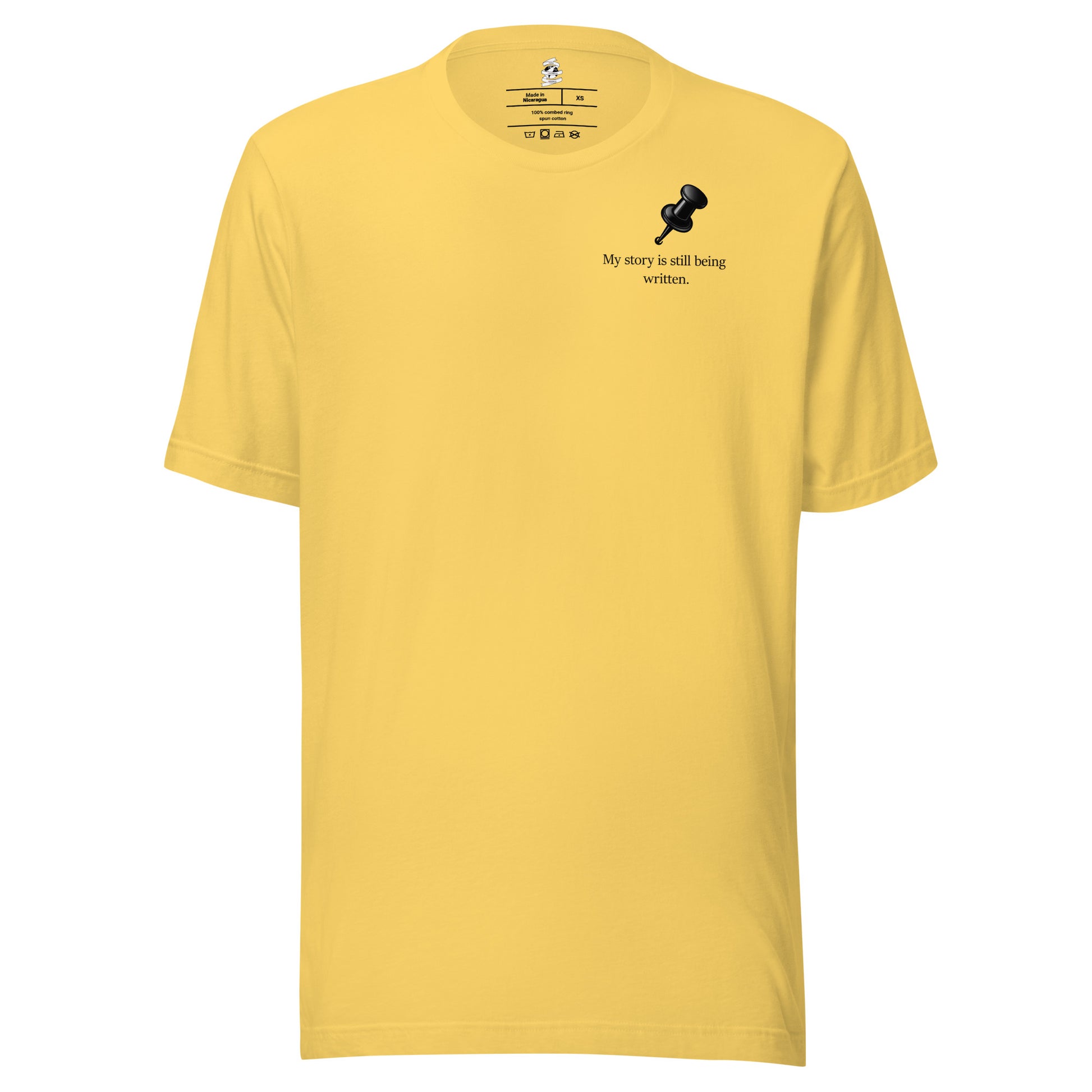 Front view of yellow  t-shirt featuring My Story Is Still Being Written slogan.