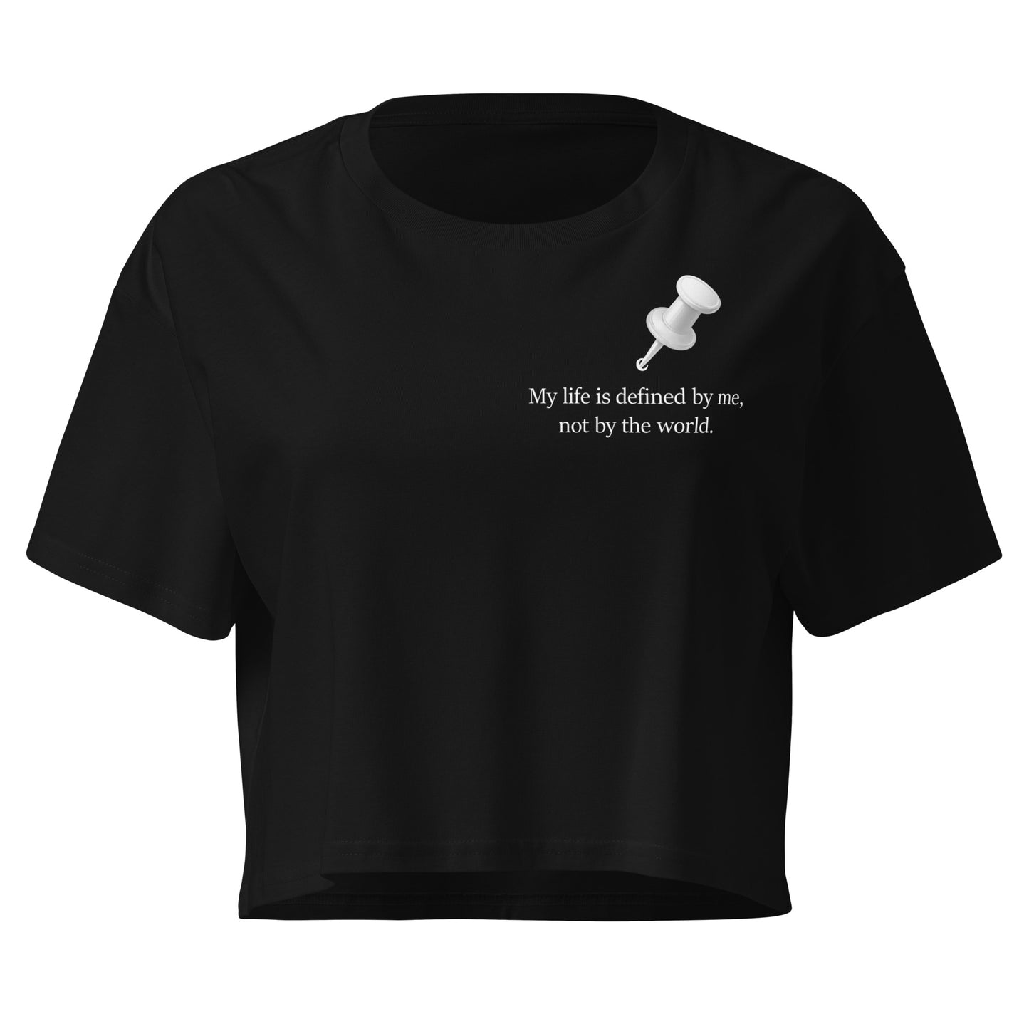 Black women's cropped cotton t-shirt featuring a white push pin graphic and the affirmation “My life is defined by me, not by the world” printed on the left chest